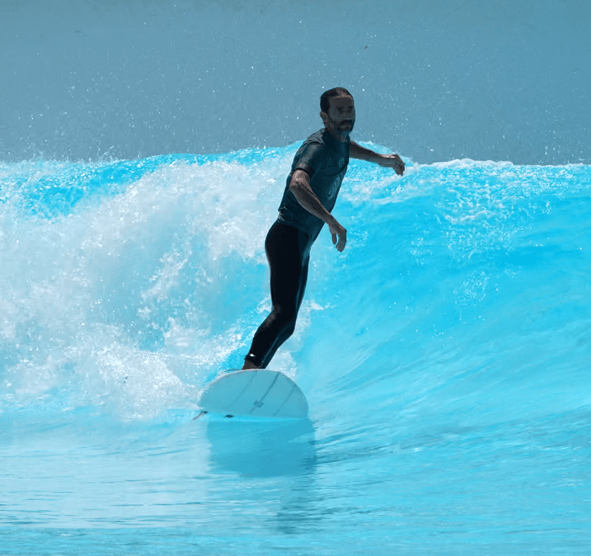 Surfer standing tall on a wave pool wave