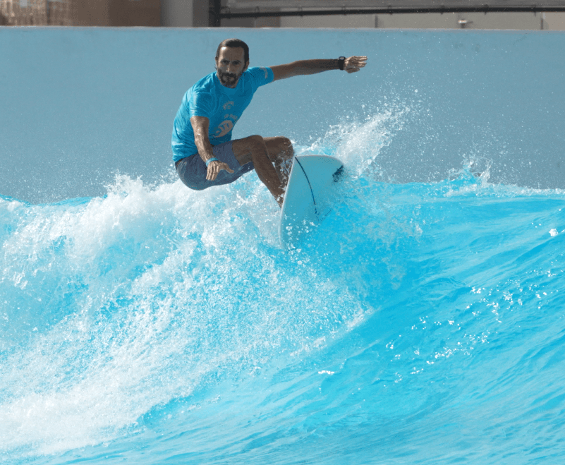 Surfer carving a turn on a wave pool wave